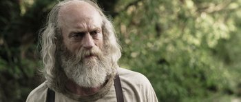 Movie still from “Z Nation” (2014), created by Karl Schaefer – An old man with a long white beard; Close Up shot, Over the shoulder angle