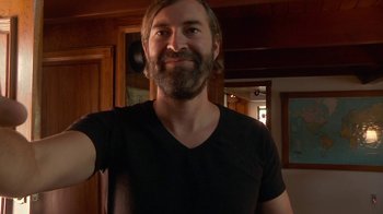 Movie still from “Creep 2” (2017), directed by Patrick Brice – A man with a beard is taking a selfie; Close Up shot, Overhead angle