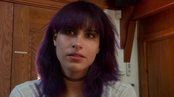 Movie still from “Creep 2” (2017), directed by Patrick Brice – A person with purple hair; Close Up shot, Over the shoulder angle