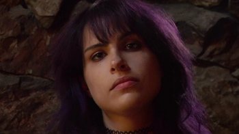 Movie still from “Creep 2” (2017), directed by Patrick Brice – A person with purple hair; Close Up shot, Low angle