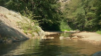 Movie still from “Creep 2” (2017), directed by Patrick Brice – A river with rocks in the middle of it; Extreme Wide shot, High angle