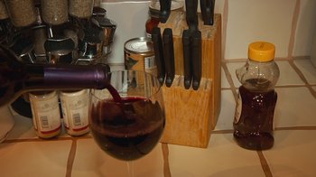 Movie still from “Creep 2” (2017), directed by Patrick Brice – A glass of red wine is being poured into a wine glass; Extreme Close Up shot, High angle