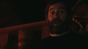 Movie still from “Creep 2” (2017), directed by Patrick Brice – A man with a goatee and a beard; Close Up shot, Low angle