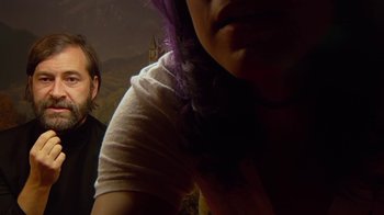 Movie still from “Creep 2” (2017), directed by Patrick Brice – A woman with purple hair is looking at a man; Close Up shot, High angle