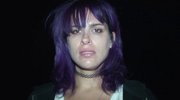 Movie still from “Creep 2” (2017), directed by Patrick Brice – A person with purple hair; Close Up shot, Low angle