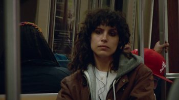 Movie still from “Creep 2” (2017), directed by Patrick Brice – A woman sitting on top of a bus listening to music; Close Up shot, High angle