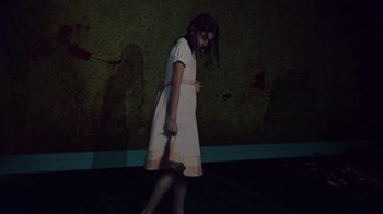 Movie still from “Creep 2” (2017), directed by Patrick Brice – A girl in a white dress holding a knife in her hand; Wide shot, Low angle