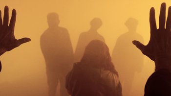 Movie still from “Z Nation” (2014), created by Karl Schaefer – A group of people that are standing in a room; Medium shot, Low angle