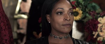 Movie still from “Z Nation” (2014), created by Karl Schaefer – A person wearing a necklace; Close Up shot, Over the shoulder angle