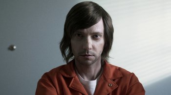 Movie still from “Z Nation” (2014), created by Karl Schaefer – A person with long brown hair; Close Up shot, Low angle