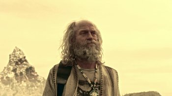 Movie still from “Z Nation” (2014), created by Karl Schaefer – An old man with long white hair and a beard; Medium shot, Low angle