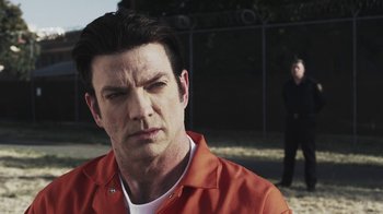 Movie still from “Z Nation” (2014), created by Karl Schaefer – A person wearing an orange shirt; Close Up shot, Over the shoulder angle