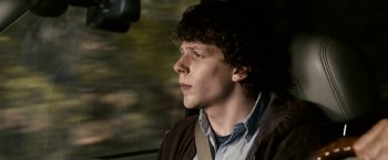 Movie still from “Zombieland” (2009), directed by Ruben Fleischer – A man sitting in the driver's seat of a car; Close Up shot, Over the shoulder angle