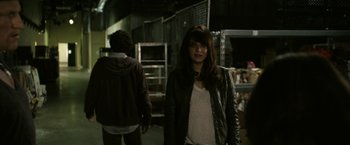 Movie still from “Zombieland” (2009), directed by Ruben Fleischer – A woman in a leather jacket standing next to a man; Medium shot, Over the shoulder angle