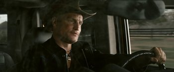Movie still from “Zombieland” (2009), directed by Ruben Fleischer – A man wearing a cowboy hat sitting in a car; Close Up shot, Low angle