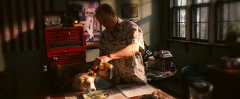 Movie still from “Zombieland” (2009), directed by Ruben Fleischer – A man is pouring a dog a bowl of food; Medium shot, Over the shoulder angle