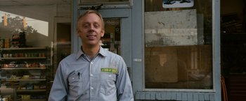 Movie still from “Zombieland” (2009), directed by Ruben Fleischer – A man standing in front of a building; Medium shot, Low angle