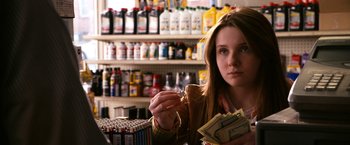 Movie still from “Zombieland” (2009), directed by Ruben Fleischer – A woman is holding money in her hand; Close Up shot, Over the shoulder angle