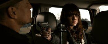 Movie still from “Zombieland” (2009), directed by Ruben Fleischer – A woman holding a gun in a car; Close Up shot, Over the shoulder angle