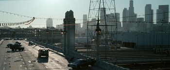 Movie still from “Zombieland” (2009), directed by Ruben Fleischer – A car is parked on the side of a bridge; Extreme Wide shot, High angle