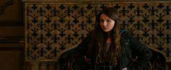 Movie still from “Zombieland” (2009), directed by Ruben Fleischer – A young woman is posing for a picture; Medium shot, High angle
