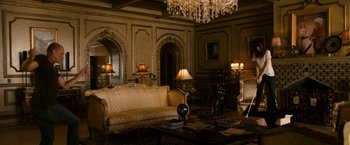 Movie still from “Zombieland” (2009), directed by Ruben Fleischer – A living room filled with furniture and a chandelier; Wide shot, High angle