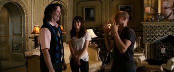 Movie still from “Zombieland” (2009), directed by Ruben Fleischer – A group of people standing in a living room; Medium shot, Over the shoulder angle