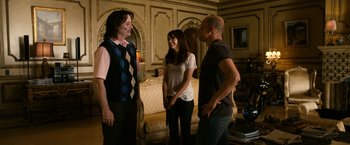 Movie still from “Zombieland” (2009), directed by Ruben Fleischer – A group of people standing in a living room; Medium shot, Over the shoulder angle