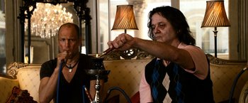 Movie still from “Zombieland” (2009), directed by Ruben Fleischer – A man is smoking a hookah while another man looks on; Medium shot, High angle