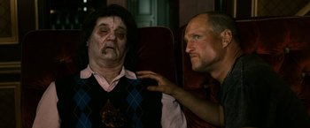 Movie still from “Zombieland” (2009), directed by Ruben Fleischer – A man touching the shoulder of a man with a face tattoo; Medium shot, Over the shoulder angle