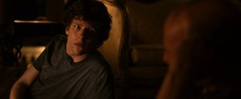 Movie still from “Zombieland” (2009), directed by Ruben Fleischer – A man sitting in front of another man in a room; Close Up shot, Over the shoulder angle
