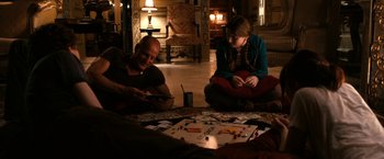 Movie still from “Zombieland” (2009), directed by Ruben Fleischer – A man and a woman sitting on the floor playing a board game; Wide shot, High angle