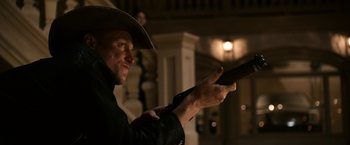Movie still from “Zombieland” (2009), directed by Ruben Fleischer – A man in a cowboy hat holding a gun; Medium shot, Low angle