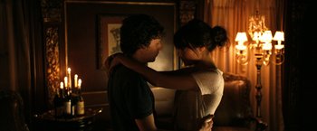 Movie still from “Zombieland” (2009), directed by Ruben Fleischer – A man and a woman embracing each other in a living room; Medium shot, Over the shoulder angle