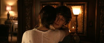Movie still from “Zombieland” (2009), directed by Ruben Fleischer – A man and a woman hugging each other in front of a fireplace; Close Up shot, Over the shoulder angle