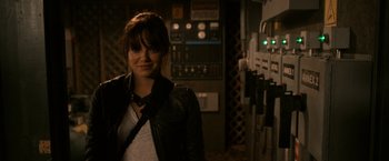 Movie still from “Zombieland” (2009), directed by Ruben Fleischer – A woman standing in front of a control panel; Medium shot, Over the shoulder angle