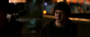 Movie still from “Zombieland” (2009), directed by Ruben Fleischer – A man with curly hair standing in the dark; Close Up shot, Over the shoulder angle
