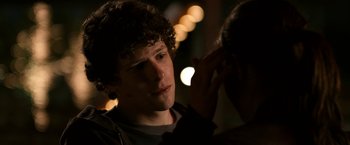 Movie still from “Zombieland” (2009), directed by Ruben Fleischer – A young man looking into a mirror while holding his hand to his ear; Close Up shot, Over the shoulder angle