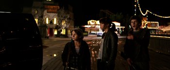 Movie still from “Zombieland” (2009), directed by Ruben Fleischer – Two people standing on the sidewalk at night; Medium shot, Over the shoulder angle