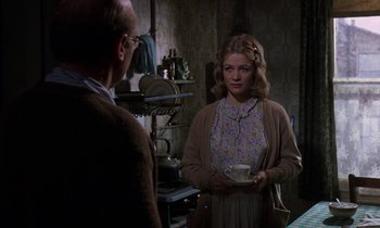 Movie still from “10 Rillington Place” (1971), directed by Richard Fleischer – A woman holding a tea cup in front of an older man; Medium shot, Over the shoulder angle