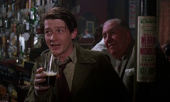 Movie still from “10 Rillington Place” (1971), directed by Richard Fleischer – A man holding a glass of beer in front of another man; Medium shot, Over the shoulder angle