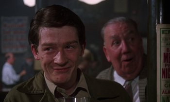 Movie still from “10 Rillington Place” (1971), directed by Richard Fleischer – A man and a man with a glass of wine; Close Up shot, Over the shoulder angle