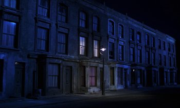 Movie still from “10 Rillington Place” (1971), directed by Richard Fleischer – A street light in front of a building at night; Extreme Wide shot, Low angle