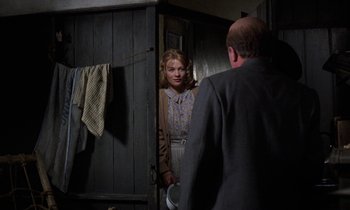 Movie still from “10 Rillington Place” (1971), directed by Richard Fleischer – A man and a woman standing in front of a door; Medium shot, Over the shoulder angle
