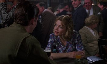 Movie still from “10 Rillington Place” (1971), directed by Richard Fleischer – A woman sitting at a table with a glass of beer in front of a man; Medium shot, Over the shoulder angle