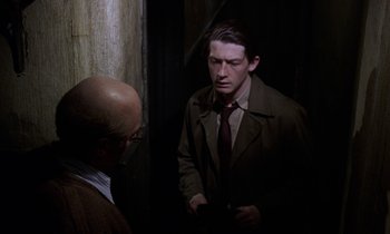 Movie still from “10 Rillington Place” (1971), directed by Richard Fleischer – A man in a brown jacket and a man in a brown tie; Medium shot, Over the shoulder angle