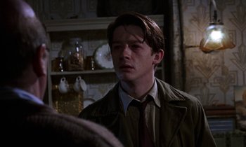 Movie still from “10 Rillington Place” (1971), directed by Richard Fleischer – A man in a brown jacket and a red tie; Close Up shot, Over the shoulder angle