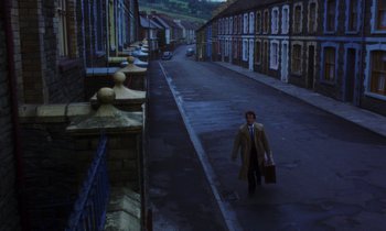 Movie still from “10 Rillington Place” (1971), directed by Richard Fleischer – A man walking down the street holding a briefcase; Extreme Wide shot, High angle