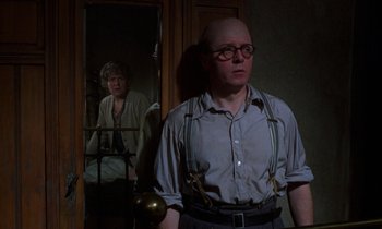 Movie still from “10 Rillington Place” (1971), directed by Richard Fleischer – A man and a woman standing next to each other in front of a mirror; Medium shot, Over the shoulder angle
