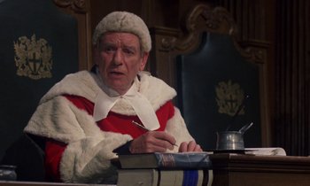 Movie still from “10 Rillington Place” (1971), directed by Richard Fleischer – An old man wearing a fur coat and a white hat; Medium shot, High angle